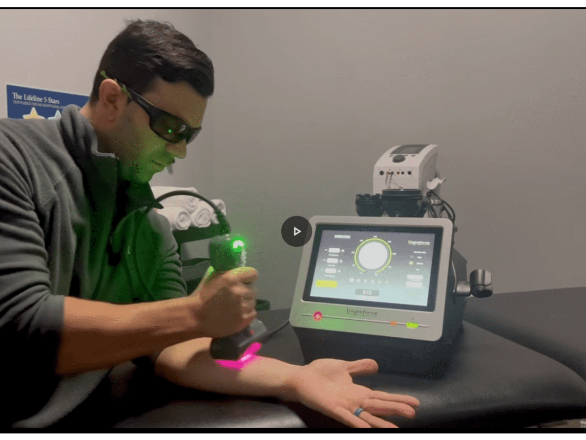 Close-up of a Class IV laser device used in physical therapy for pain relief and tissue healing.