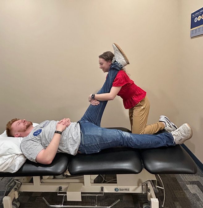 physical therapist stretching patient
